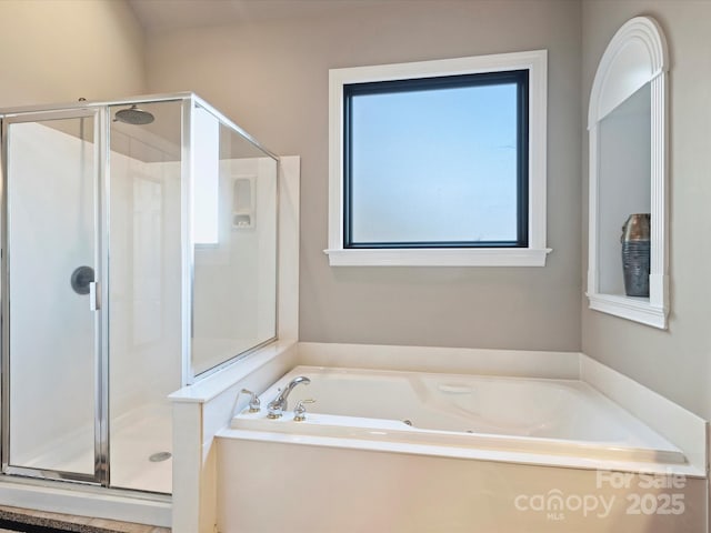 full bathroom with a stall shower and a garden tub