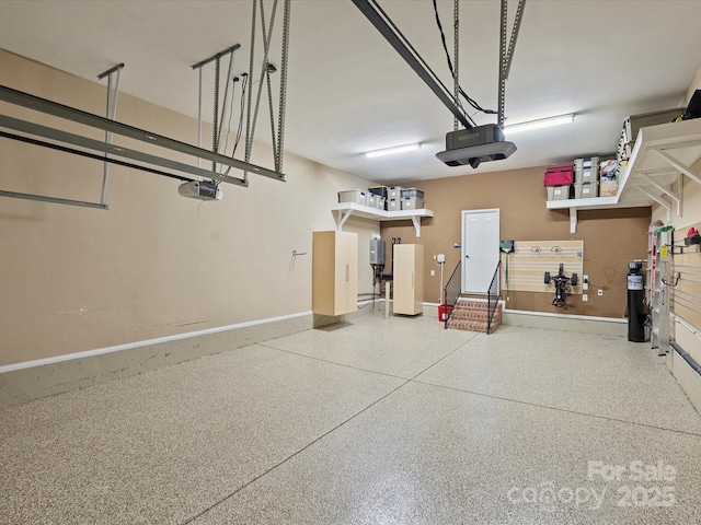 garage with baseboards and a garage door opener