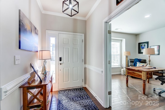 foyer featuring dark hardwood / wood-style flooring and crown molding