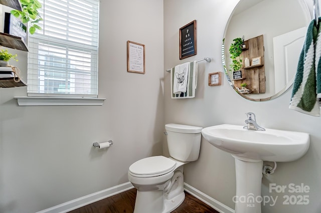 bathroom with hardwood / wood-style floors and toilet