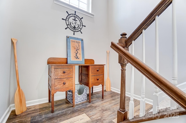 stairs featuring hardwood / wood-style floors