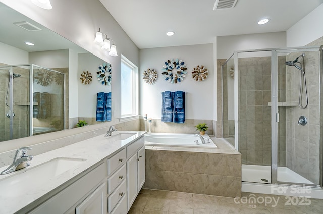 bathroom with tile patterned floors, vanity, and separate shower and tub