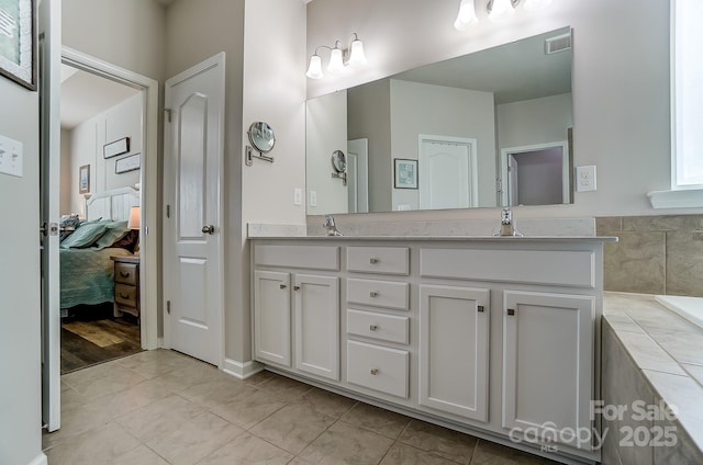 bathroom with tile patterned flooring and vanity