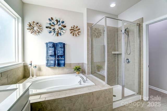 bathroom with vanity, a wealth of natural light, shower with separate bathtub, and tile patterned floors