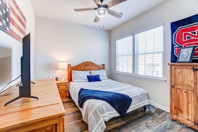 bedroom with ceiling fan and dark wood-type flooring