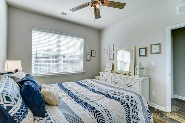 bedroom with ceiling fan and dark hardwood / wood-style flooring