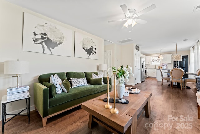 living room with dark hardwood / wood-style floors and ceiling fan