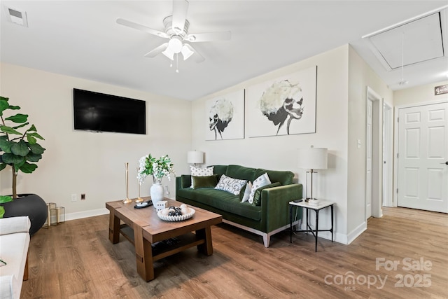 living room featuring hardwood / wood-style floors and ceiling fan