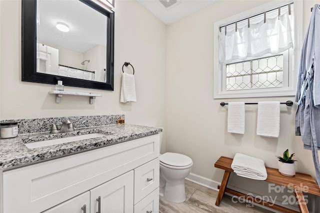 bathroom with vanity, toilet, and a shower with shower curtain