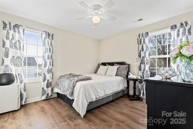 bedroom with dark wood-type flooring and ceiling fan