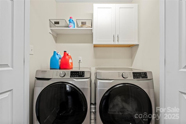 laundry room featuring cabinets and washing machine and dryer