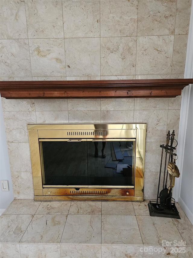 room details featuring a tile fireplace