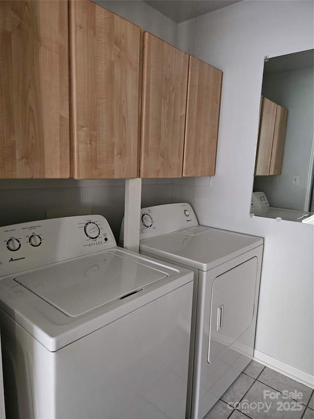 laundry room with cabinet space, washer and clothes dryer, and light tile patterned floors