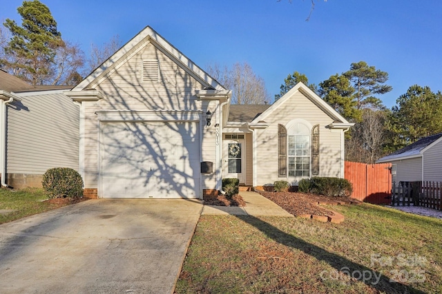 view of property featuring a garage and a front yard