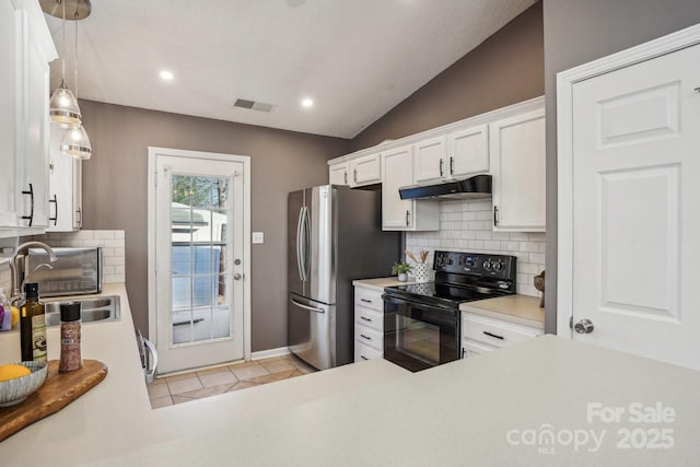 kitchen with black electric range oven, vaulted ceiling, decorative light fixtures, sink, and white cabinetry