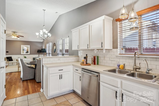 kitchen featuring sink, dishwasher, white cabinetry, and pendant lighting