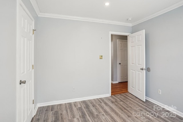 unfurnished bedroom with crown molding and light hardwood / wood-style floors