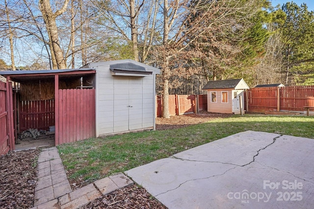 view of yard featuring a patio and a storage shed