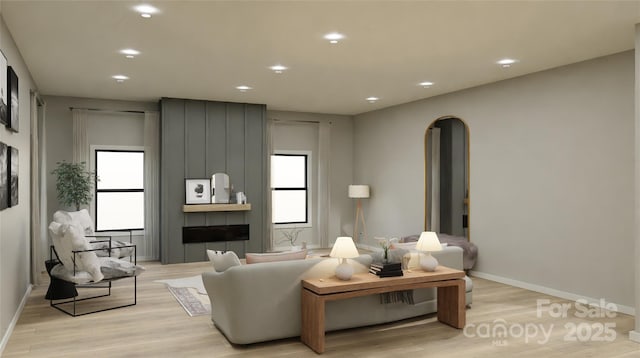 living room with a healthy amount of sunlight and light hardwood / wood-style floors