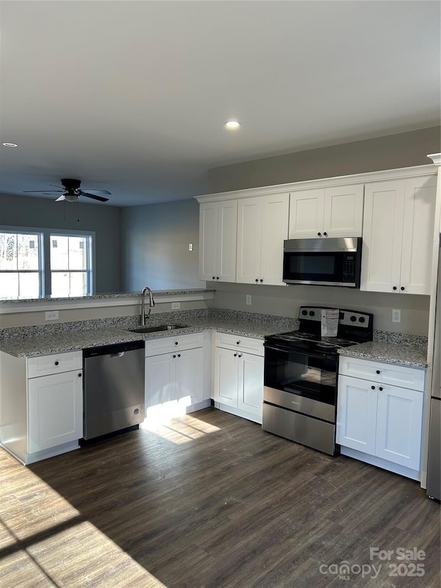 kitchen with sink, stainless steel appliances, and white cabinetry