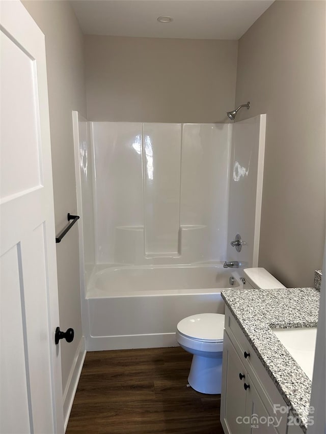 full bathroom with toilet, hardwood / wood-style flooring, vanity, and bathtub / shower combination