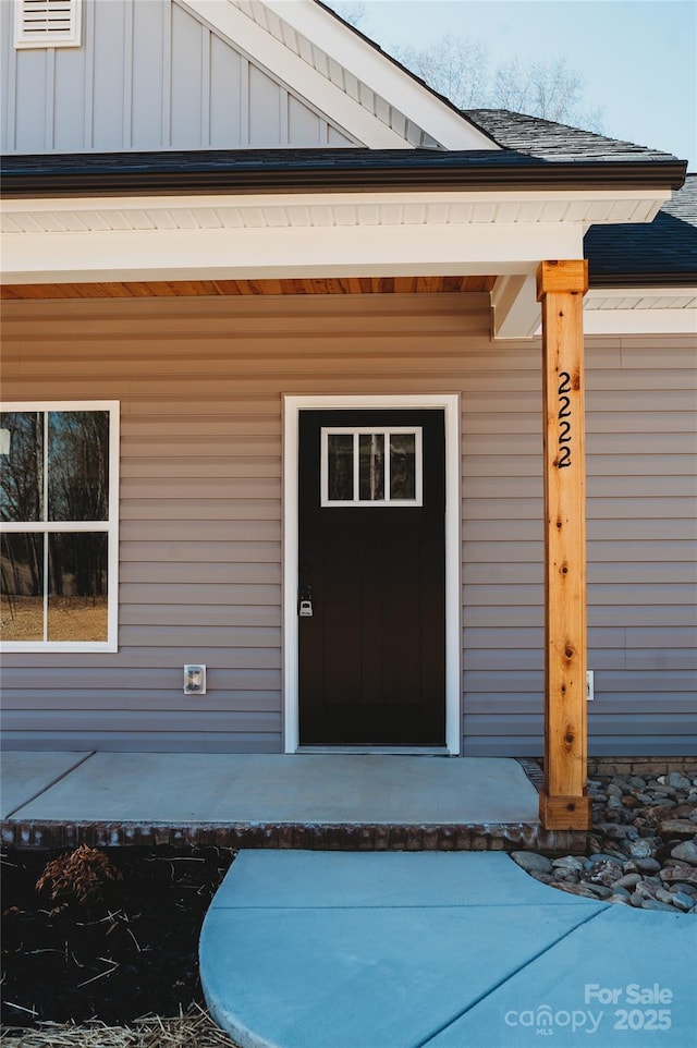 property entrance featuring visible vents and board and batten siding