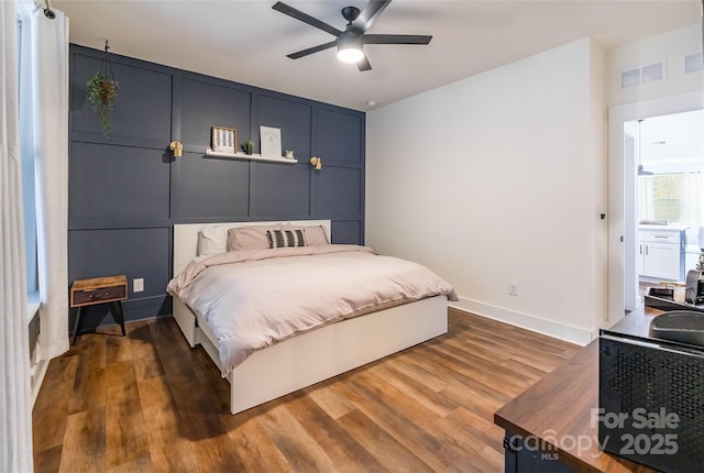 bedroom with ceiling fan and dark hardwood / wood-style floors