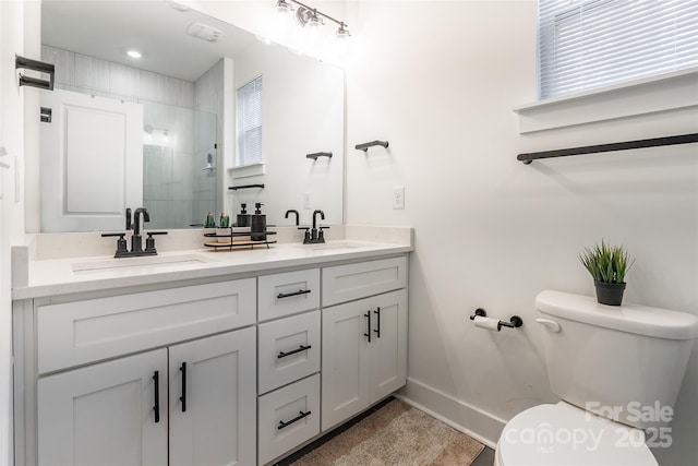 bathroom featuring toilet, walk in shower, and vanity