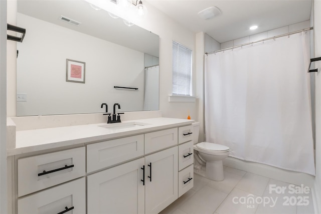 full bathroom featuring toilet, tile patterned flooring, vanity, and shower / bath combo with shower curtain