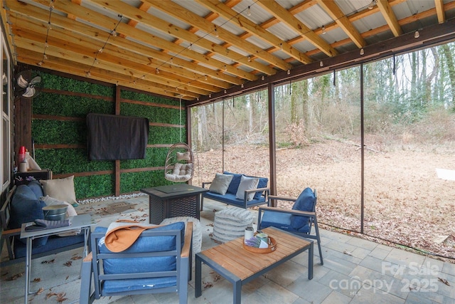 sunroom featuring lofted ceiling