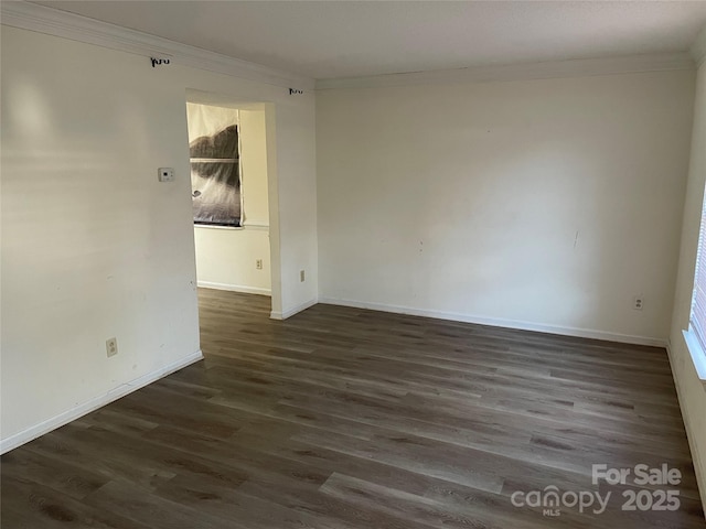 empty room featuring crown molding and dark wood-type flooring