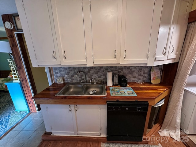 kitchen with white cabinetry, black dishwasher, and sink