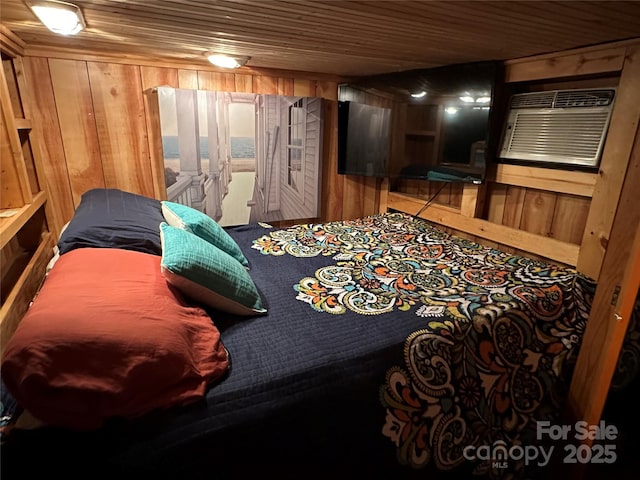 bedroom with wooden ceiling, a wall unit AC, and wood walls