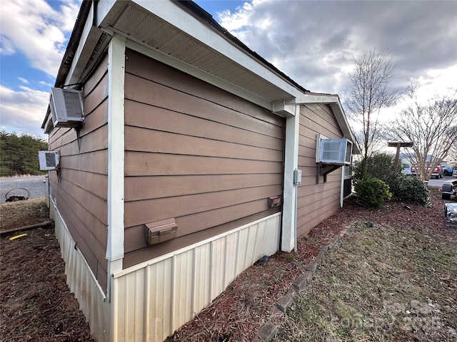 view of property exterior with an AC wall unit