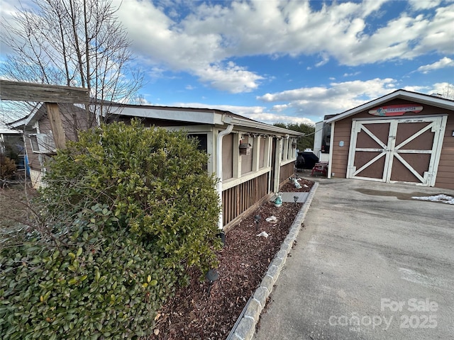 view of property exterior with a storage shed