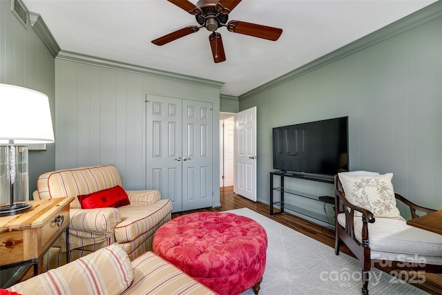 living room featuring crown molding, ceiling fan, and dark hardwood / wood-style flooring