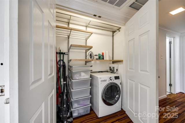 clothes washing area featuring washer / clothes dryer and dark hardwood / wood-style flooring