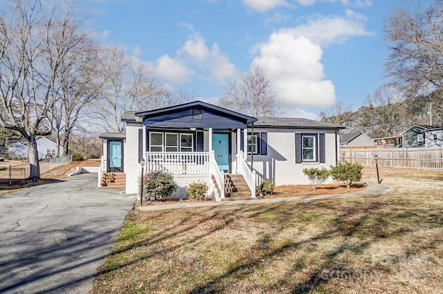 view of front of property with a front yard and a porch