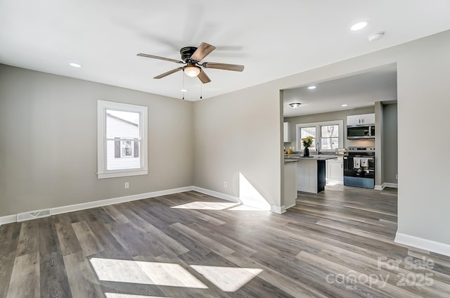 spare room featuring ceiling fan and hardwood / wood-style flooring