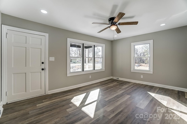 foyer entrance with ceiling fan and dark hardwood / wood-style floors