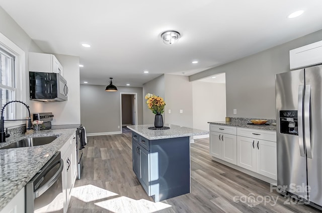 kitchen featuring light stone counters, sink, white cabinets, and stainless steel appliances