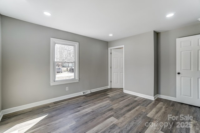 unfurnished room featuring dark hardwood / wood-style flooring