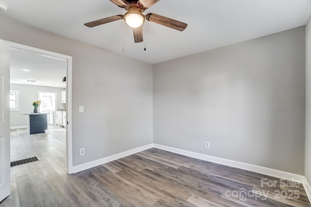 empty room featuring ceiling fan and wood-type flooring