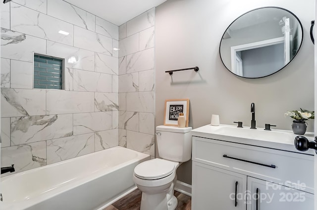 full bathroom with toilet, tiled shower / bath combo, vanity, and hardwood / wood-style floors