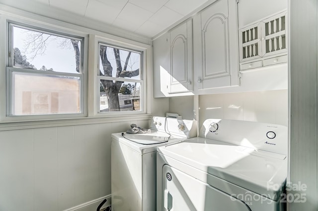 laundry area featuring washer and dryer and cabinets