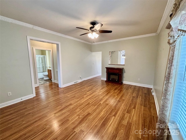 unfurnished living room featuring hardwood / wood-style flooring, ceiling fan, and ornamental molding