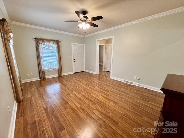 unfurnished room featuring wood-type flooring, ceiling fan, and crown molding