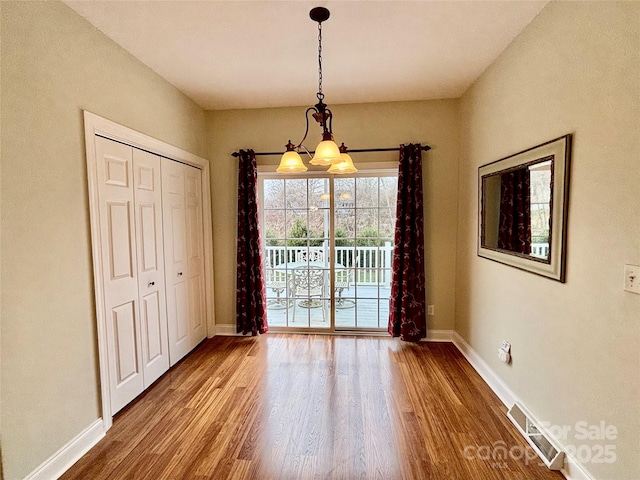 unfurnished dining area featuring hardwood / wood-style floors