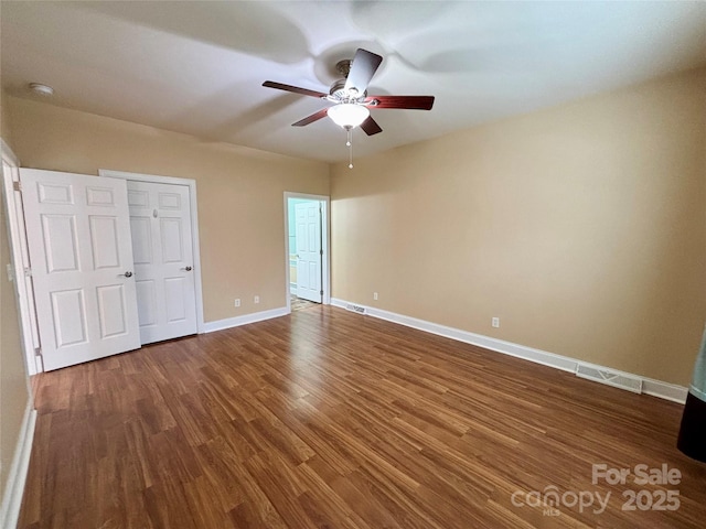 unfurnished bedroom with wood-type flooring, a closet, and ceiling fan