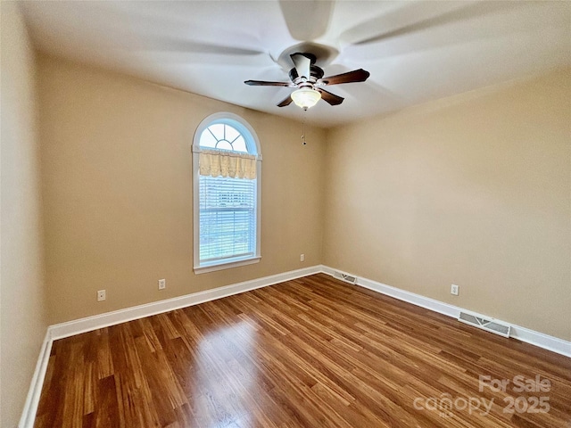 empty room with ceiling fan and wood-type flooring